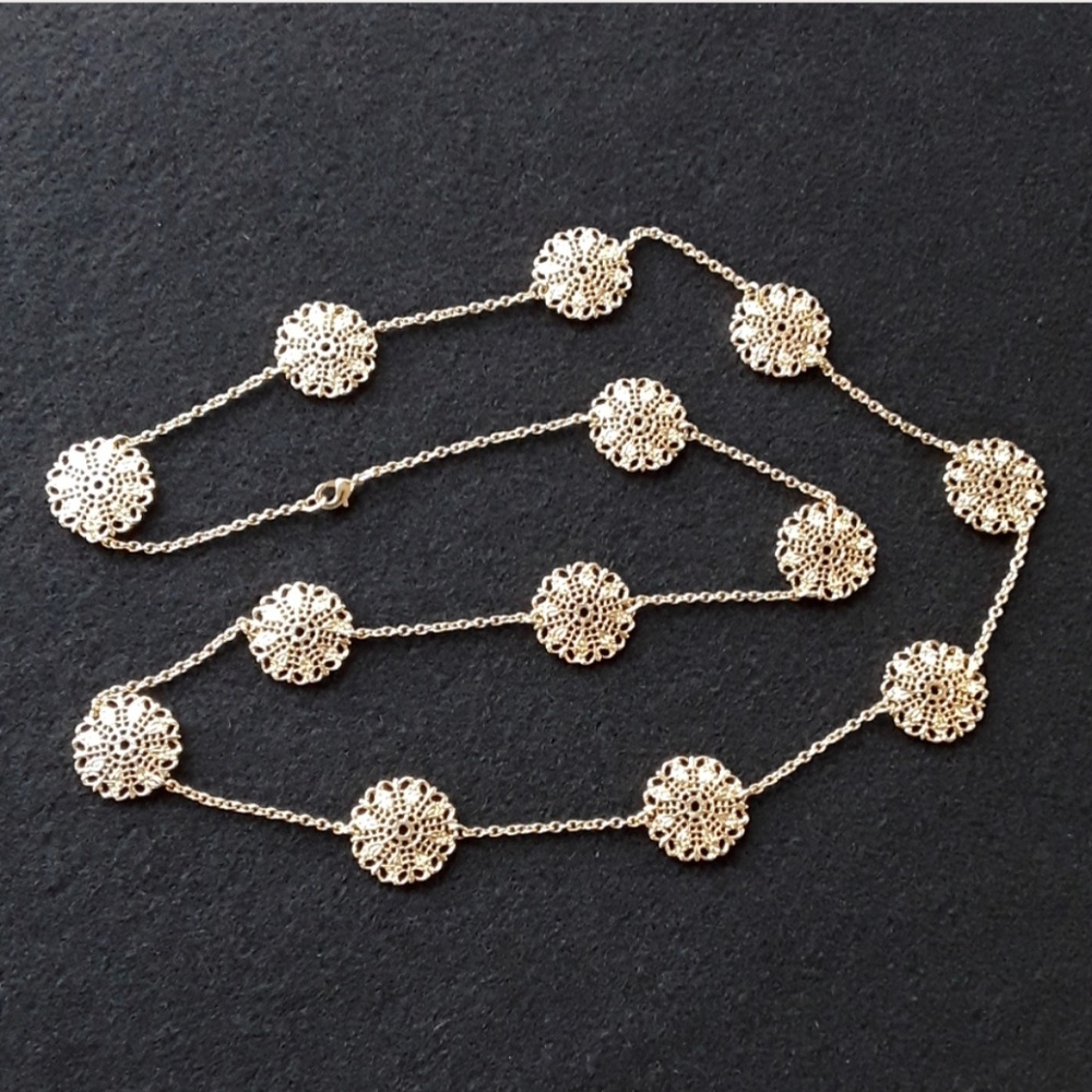 Gold tone necklace with round, filagree discs